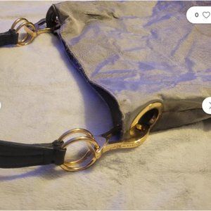 Silver / Black Leather straps. Over shoulder.